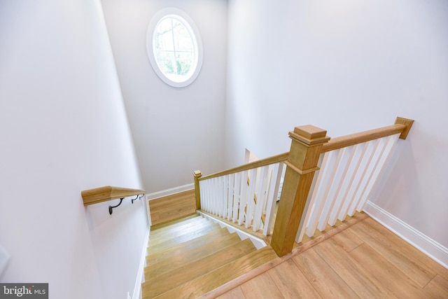 stairway with hardwood / wood-style flooring