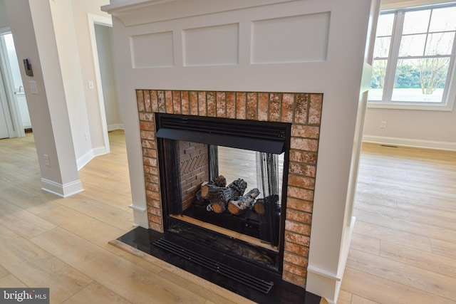 details featuring a fireplace and hardwood / wood-style flooring