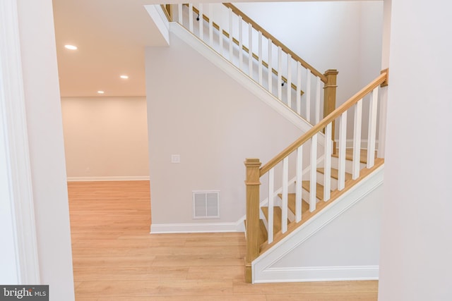 stairs with hardwood / wood-style flooring