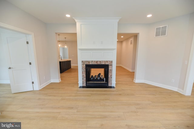 unfurnished living room featuring light hardwood / wood-style flooring