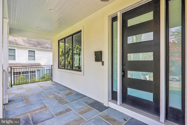 doorway to property with stucco siding