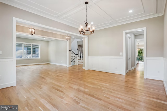 interior space with stairs, light wood-type flooring, coffered ceiling, and a notable chandelier