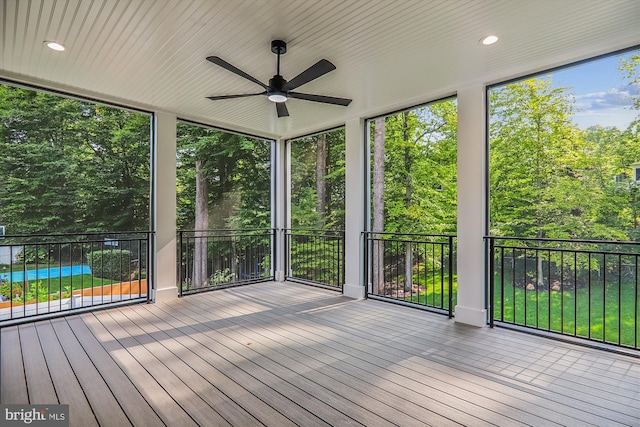 unfurnished sunroom with a ceiling fan