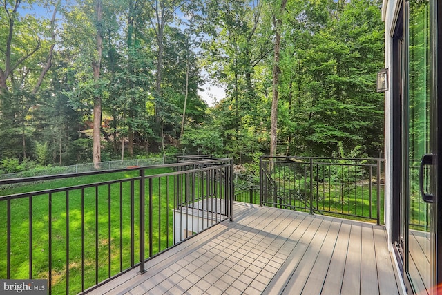 wooden deck with a lawn