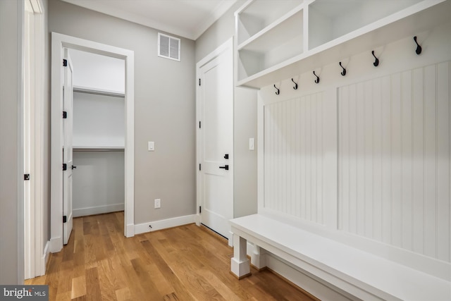 mudroom featuring baseboards, visible vents, and light wood-style floors