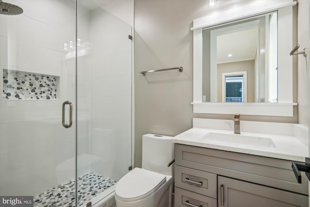 bathroom featuring a stall shower, vanity, and toilet