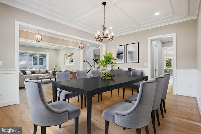 dining area featuring a wainscoted wall, stairway, coffered ceiling, and light wood-style floors