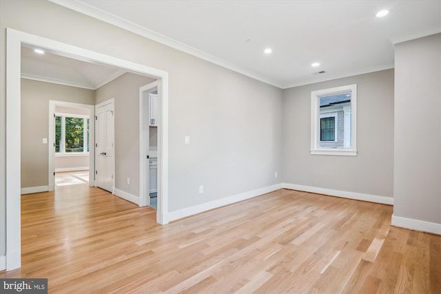 unfurnished room featuring light wood-type flooring, baseboards, crown molding, and recessed lighting