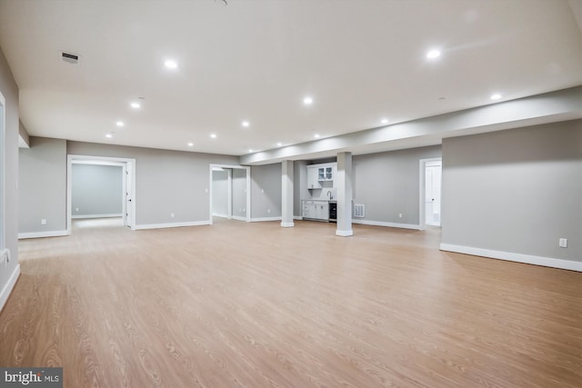 below grade area featuring light wood-type flooring, baseboards, visible vents, and recessed lighting