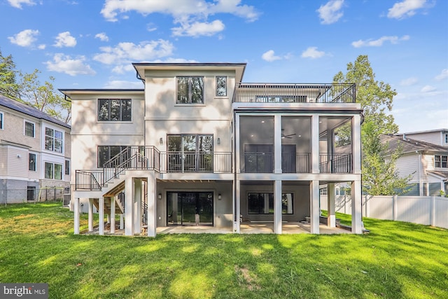 rear view of property featuring stucco siding, a fenced backyard, a lawn, and a patio