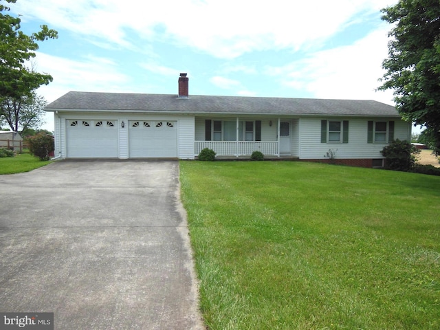 ranch-style house with a garage, a front yard, and covered porch