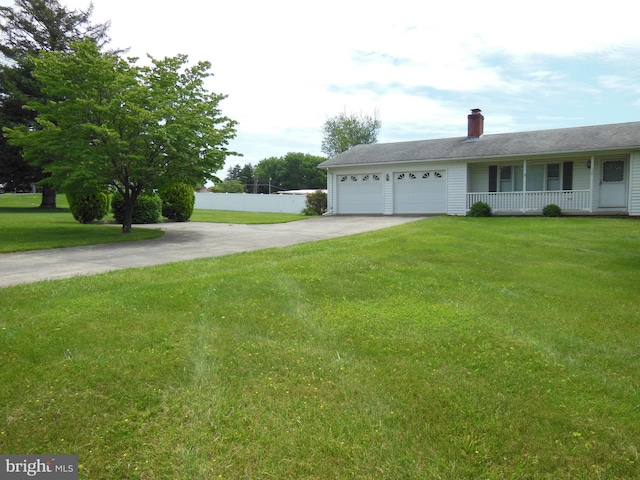 view of front of property featuring a garage and a front lawn