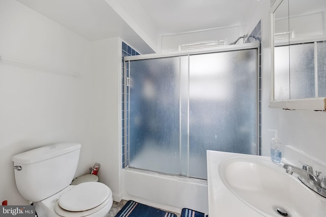 full bathroom featuring shower / bath combination with glass door, sink, and toilet