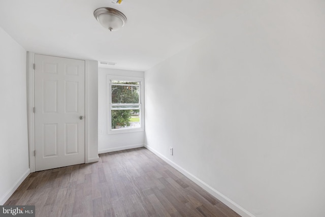 spare room with wood-type flooring