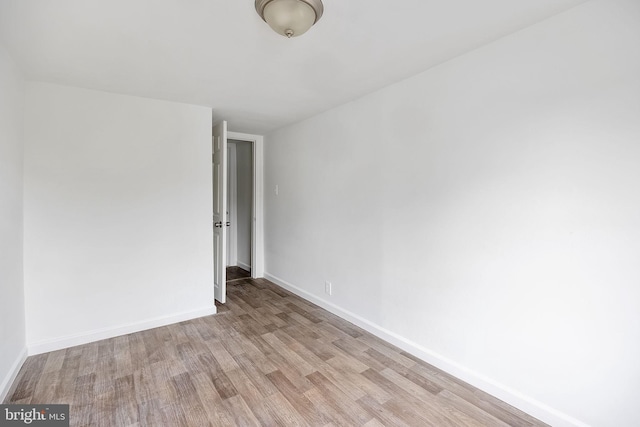 empty room with light hardwood / wood-style flooring