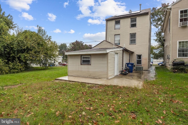 back of house with a patio, central AC, and a lawn