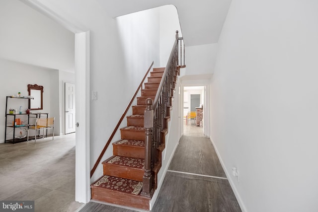 stairway with hardwood / wood-style floors