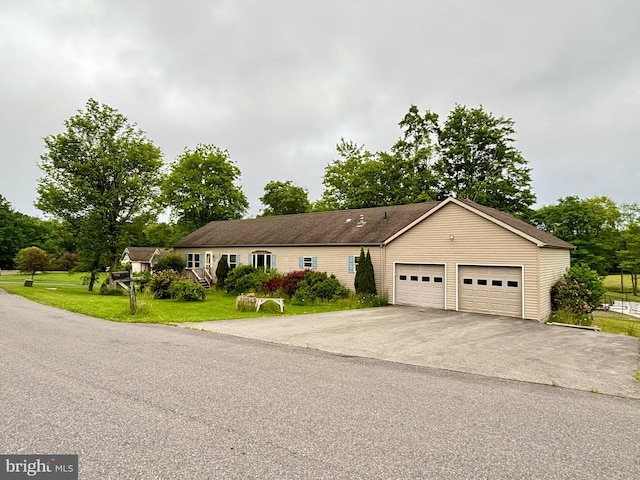 single story home featuring a garage and a front lawn