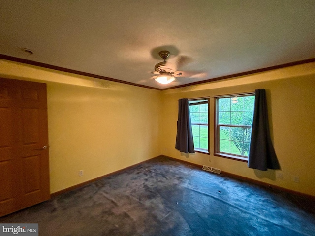 carpeted empty room featuring a textured ceiling, ceiling fan, and crown molding