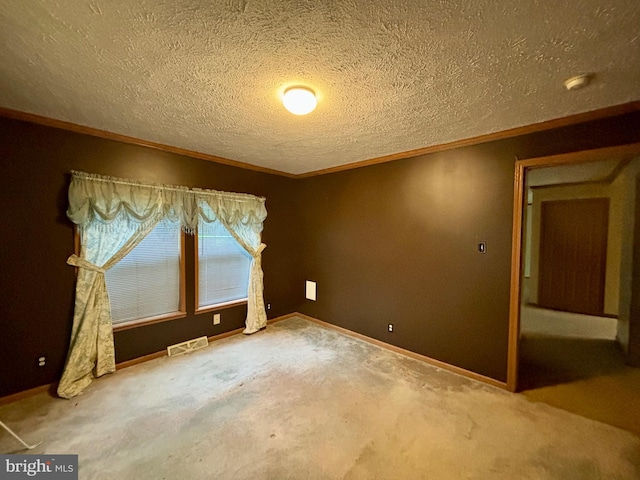 carpeted empty room featuring a textured ceiling and ornamental molding