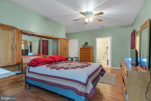 bedroom with ceiling fan, wood-type flooring, and ensuite bathroom