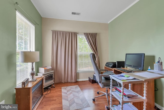 office featuring light wood-type flooring and crown molding