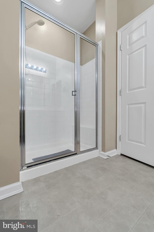 bathroom featuring tile patterned floors and an enclosed shower