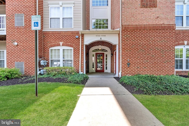 doorway to property featuring a yard