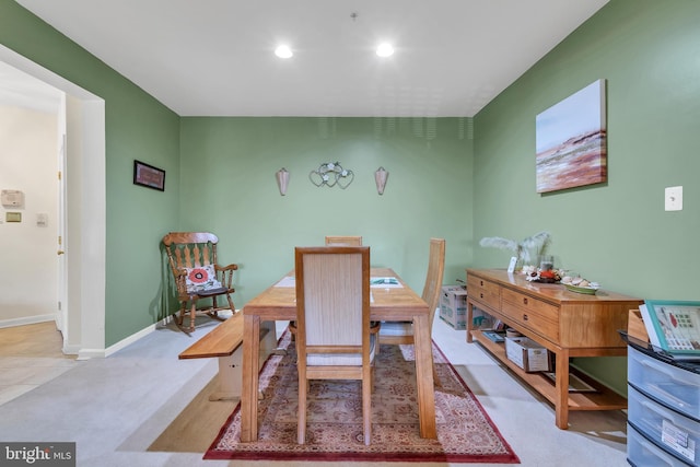 dining space with light colored carpet