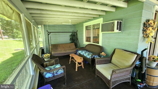 sunroom with plenty of natural light and a wall unit AC