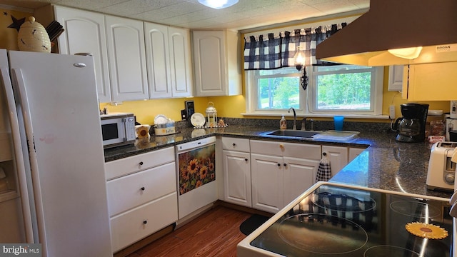 kitchen featuring sink, dark hardwood / wood-style flooring, extractor fan, white appliances, and white cabinets