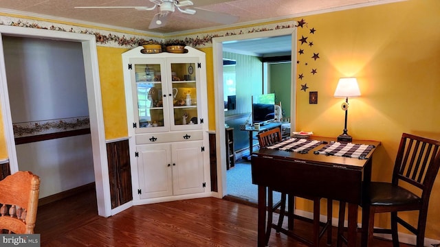 dining space featuring ceiling fan, dark hardwood / wood-style flooring, crown molding, and a baseboard heating unit