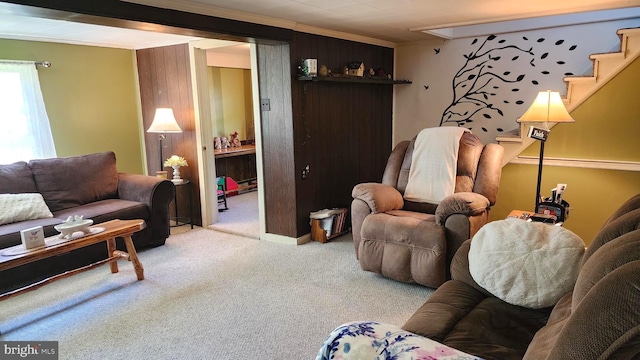 carpeted living room featuring ornamental molding