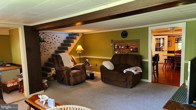 carpeted living room with ornamental molding