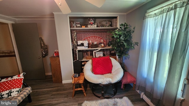 sitting room with dark hardwood / wood-style flooring and crown molding