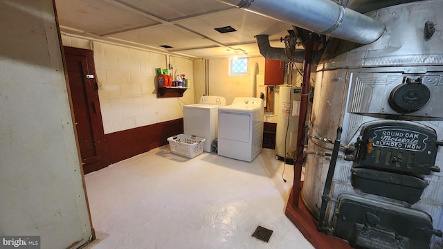 basement with separate washer and dryer and electric water heater