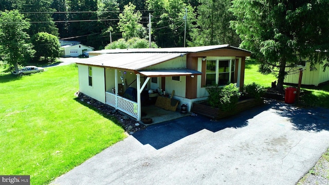 view of front of home featuring covered porch and a front yard