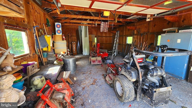 garage featuring a garage door opener and wooden walls