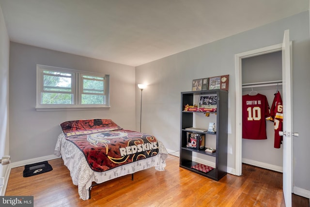 bedroom featuring wood-type flooring and a closet