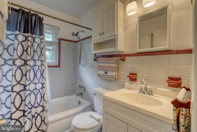 full bathroom with vanity, backsplash, toilet, shower / bath combo with shower curtain, and tile walls