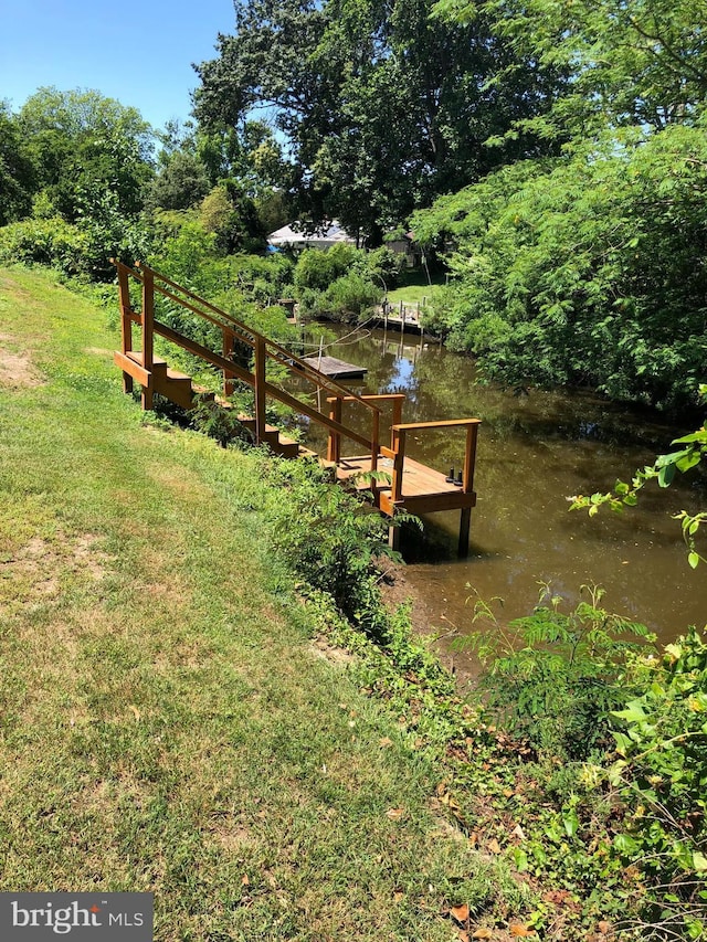 exterior space featuring a water view and a boat dock