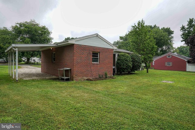 view of side of property with a yard and a carport