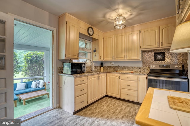 kitchen featuring decorative backsplash, light brown cabinetry, stainless steel electric stove, sink, and light hardwood / wood-style floors