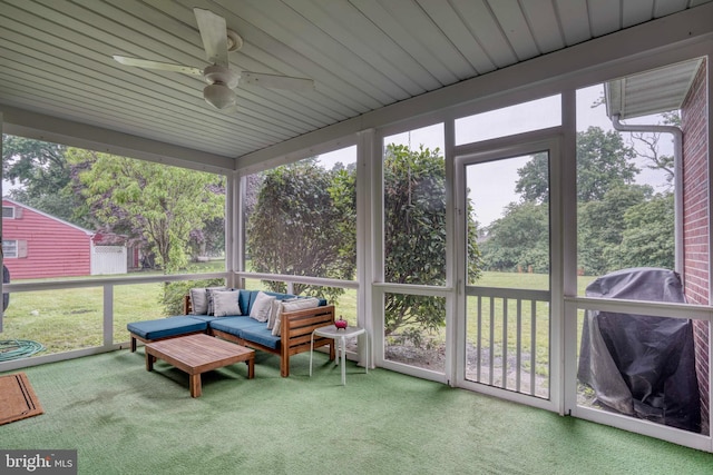 sunroom featuring ceiling fan, plenty of natural light, and wood ceiling