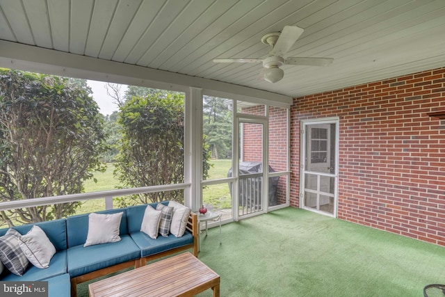 sunroom featuring ceiling fan, plenty of natural light, and wood ceiling