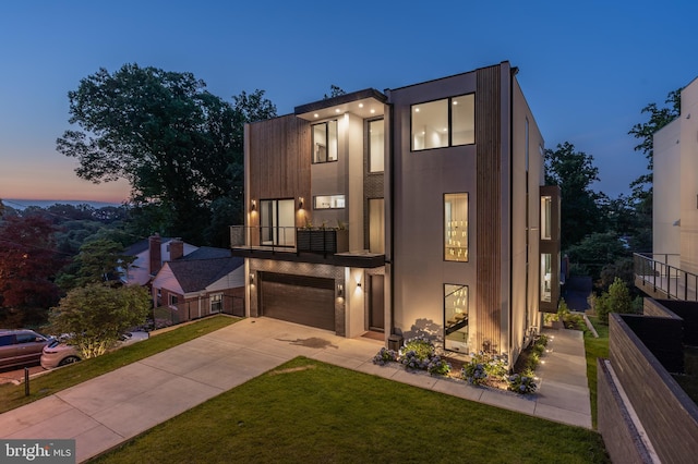 contemporary house featuring a lawn and a garage