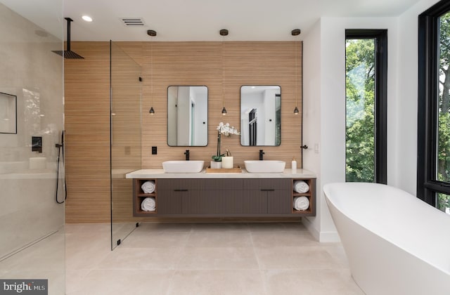 bathroom with backsplash, tile patterned flooring, vanity, and shower with separate bathtub