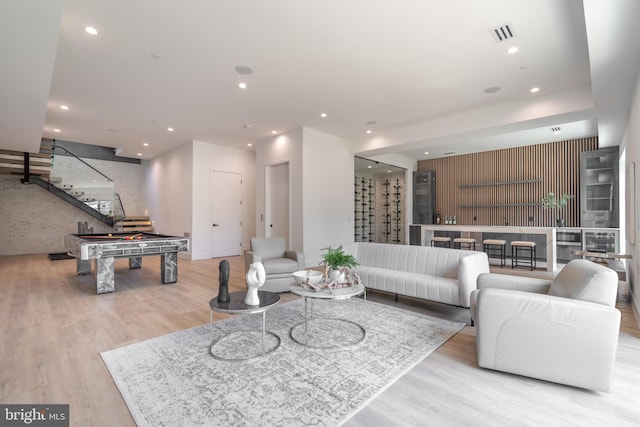 living room with light wood-type flooring and billiards