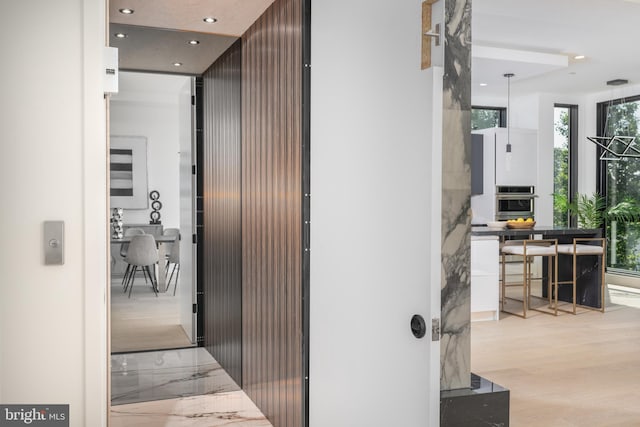 corridor with light hardwood / wood-style flooring