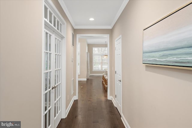 corridor with french doors, dark hardwood / wood-style floors, and ornamental molding